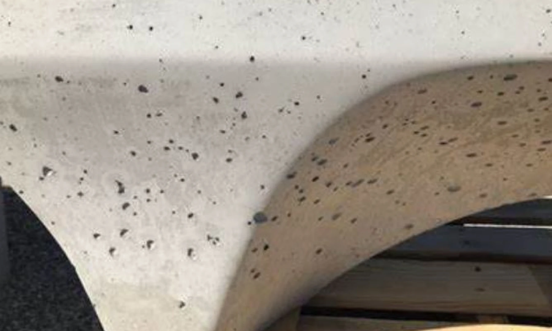 Close-up of bugholes on concrete surface